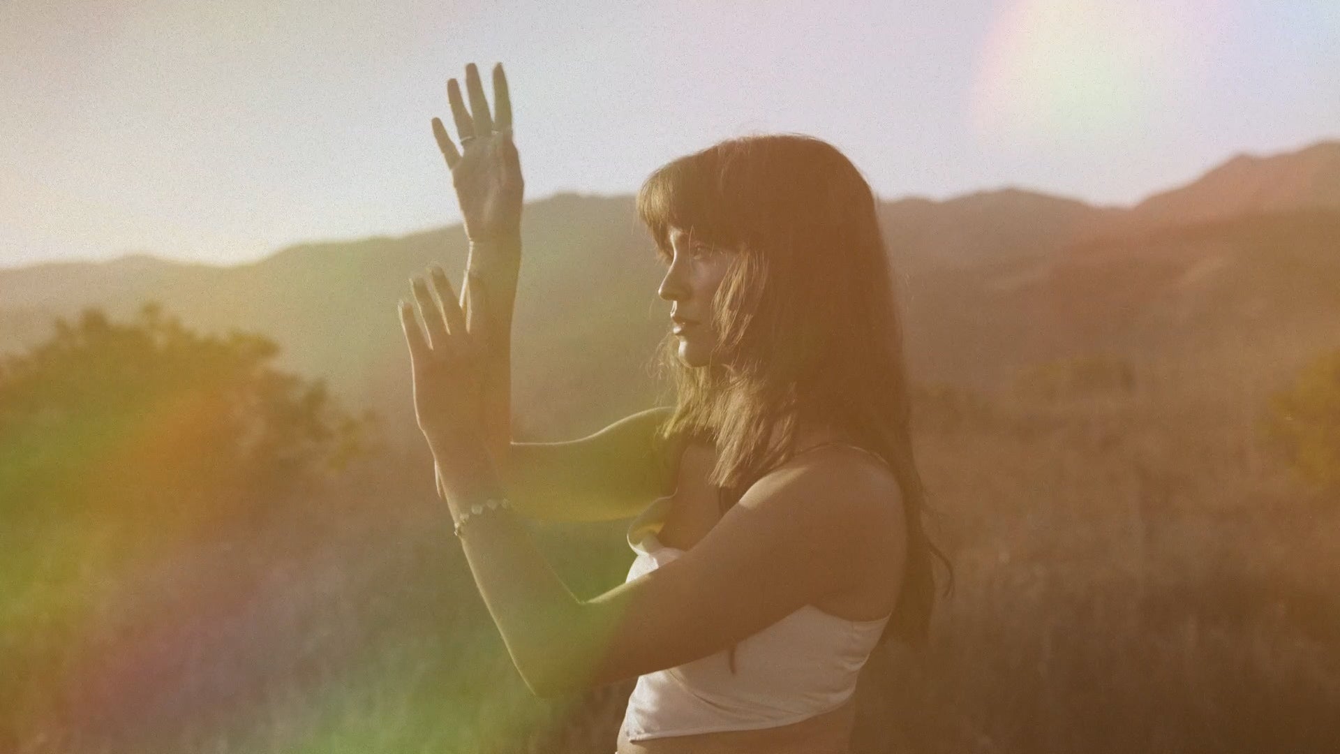Load video: Tishmal dances in the hills above the ocean in her music video for the song &quot;On My Way Up&quot;.